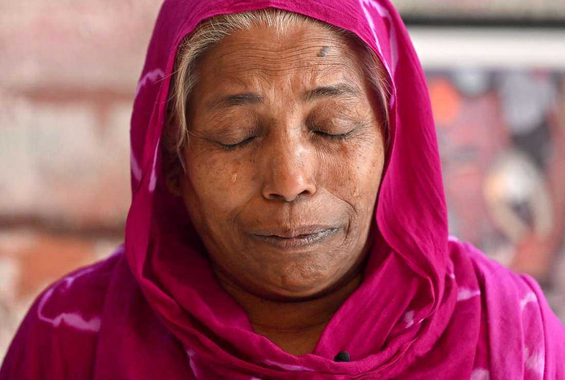 In this photograph taken on April 12, 2023, Safia Begum, mother of a garment worker killed in the Rana Plaza building collapse disaster, weeps during an interview in Dhaka