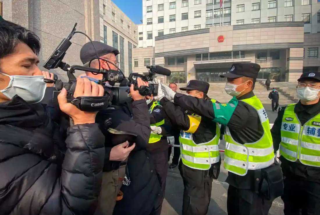 Police attempt to stop journalists from recording footage outside the Shanghai Pudong New District People’s Court, where Chinese citizen journalist Zhang Zhan was on trial in 2020