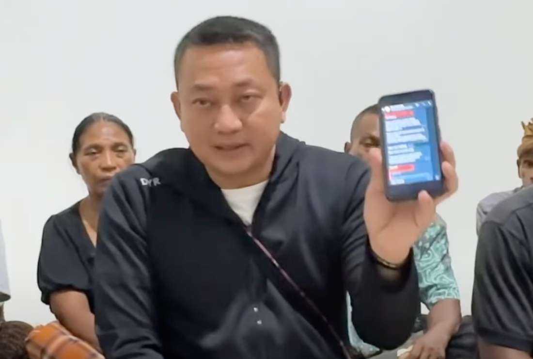 Yudha Pranata, chief of police in Nagekeo District of Indonesia's Flores Island shows a chat screenshot containing plans to commit violence against a Catholic journalist