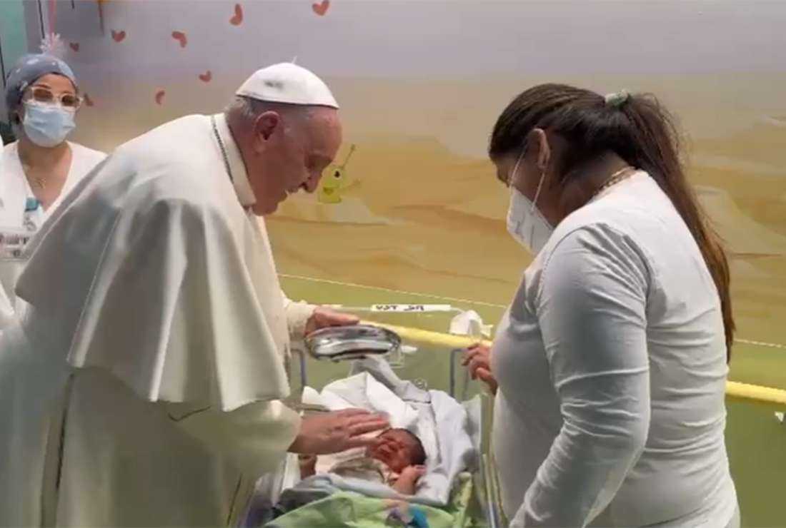 This photo grabbed from a video taken and handout by The Vatican Media on March 31 shows Pope Francis baptizing a baby boy named Miguel Angel, while visiting children at the oncology ward of the Gemelli hospital in Rome, the same hospital where the Pope was admitted to another ward on March 29 for bronchitis