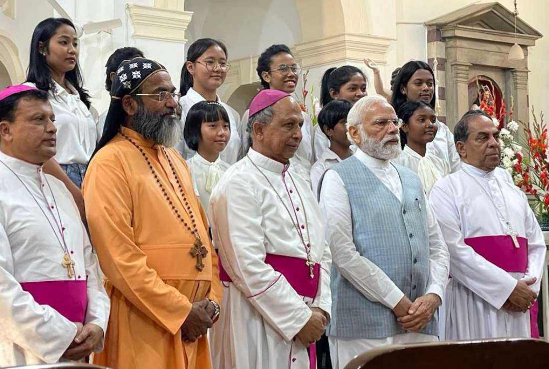Indian Prime Minister Narendra Modi, who visited the Sacred Heart Cathedral in New Delhi on Easter Sunday, April 9, poses for a photograph with Catholic bishops based in New Delhi and cathedral choir members