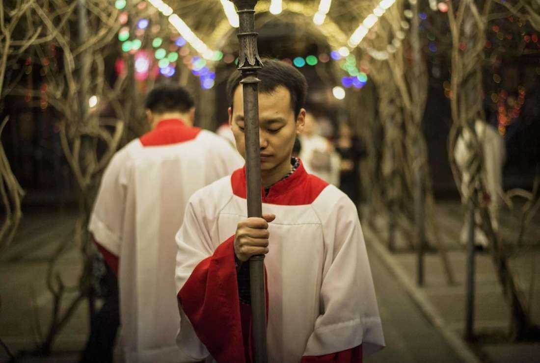 A young Chinese worshipper attends a Christmas Eve Mass at a Catholic Church in Beijing on Dec. 24, 2014