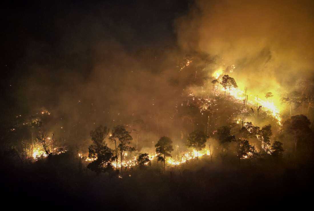 A forest fire burns on a mountain-side in Nakhon Nayok province, northeast of Bangkok on March 31, 2023