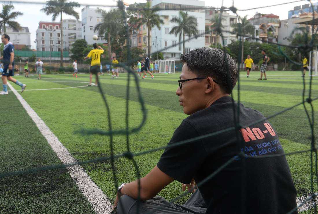 In this file photo taken on July 9, 2017, Vietnam's activist Nguyen Lan Thang watch members of te No-U FC squad play in their weekly football match at a local pitch in Hanoi.