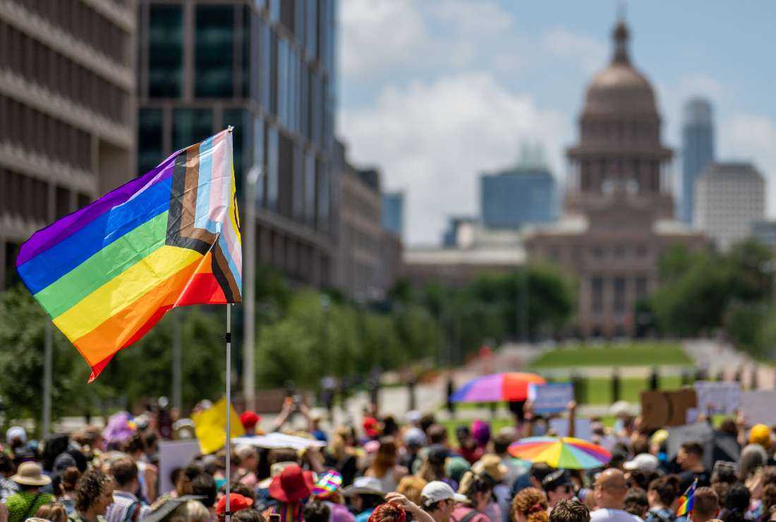  A Pride flag is seen held up in a crowd during preparation for a Queer March to the Texas State Capitol on April 15, in Austin, Texas