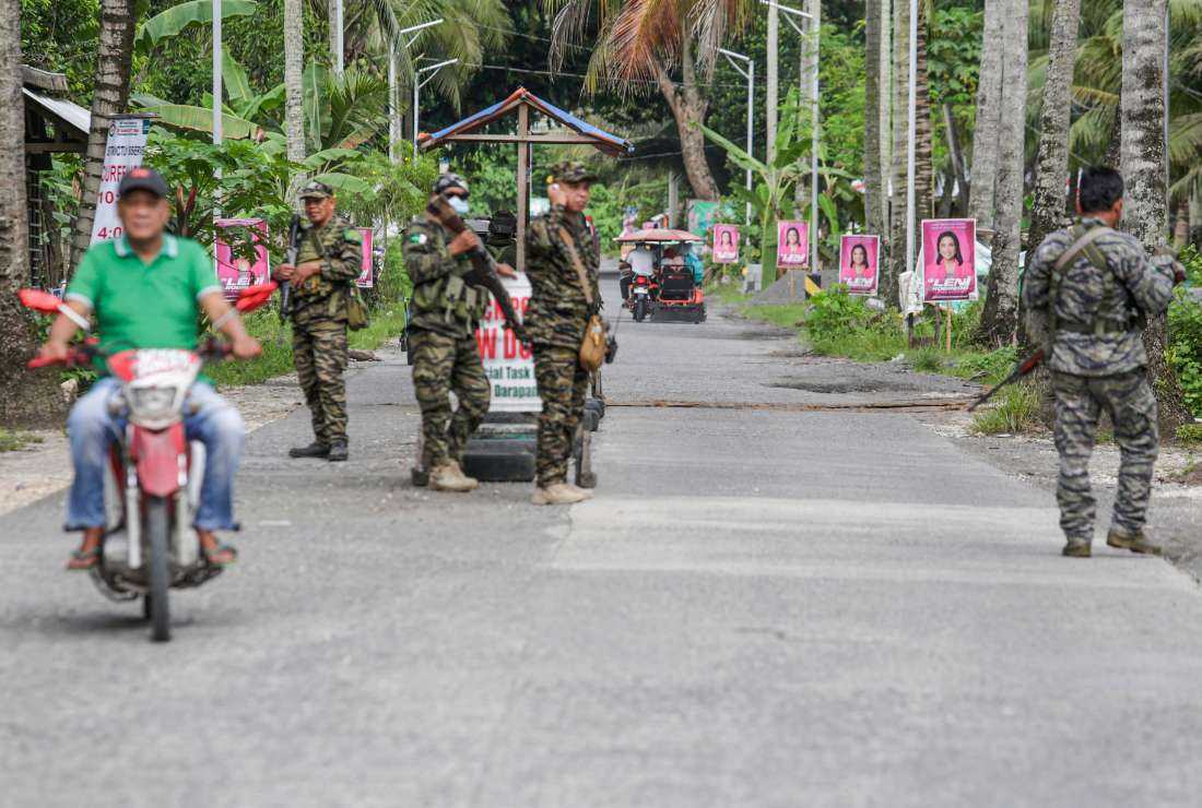 Moro Islamic Liberation Front (MILF) troops stand along a road inside Camp Darapanan in Sultan Kudarat, Maguindanao on April 23, 2022