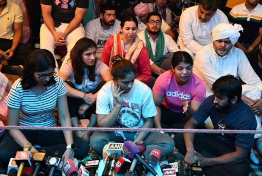 Indian wrestlers accompanied by Delhi Commission for Women chairperson Swati Maliwal (left) and other supporters, talk to the media during an ongoing protest against Brij Bhushan Sharan Singh, the chief of the Wrestling Federation of India, alleging sexual harassment by him, in New Delhi on May 4