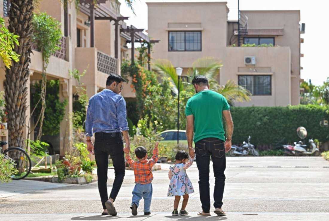 An Indian same-sex couple walk outside their home with their adopted children in Bengaluru on Feb. 11. The Supreme Court of India last week completed a ten-day-long hearing on a clutch of petitions seeking official recognition of same-sex unions but reserved its judgment on whether the Indian state legally should recognize same-sex marriages or not