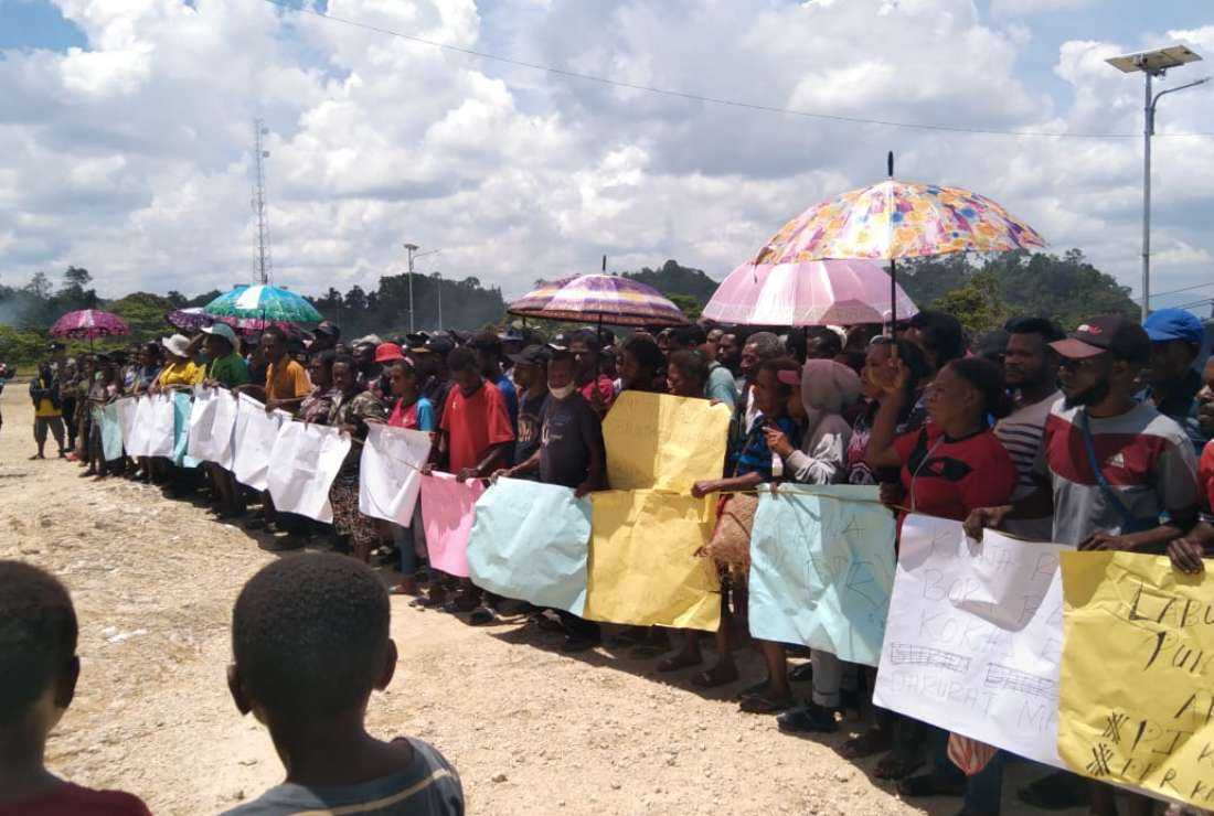 Papuans hold a rally before the parliament office to oppose the addition of more troops to their region in West Papua province in April 2023