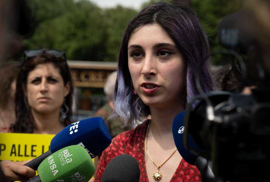 Climate change activist Ester Goffi speaks to the media as she arrives at the Vatican on May 24 to attend a hearing for having glued herself with a fellow activist to the statue of 'Laocoon and His Sons' at the Vatican Museums in August 2022