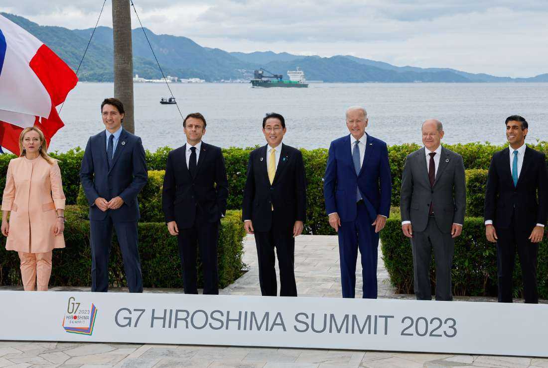 Italy's Prime Minister Giorgia Meloni, Canada's Prime Minister Justin Trudeau, France's President Emmanuel Macron, Japan's Prime Minister Fumio Kishida, US President Joe Biden, Germany's Chancellor Olaf Scholz, and Britain's Prime Minister Rishi Sunak participate in a family photo with G7 leaders before their working lunch meeting on economic security at the Grand Prince Hotel in Hiroshima on May 20