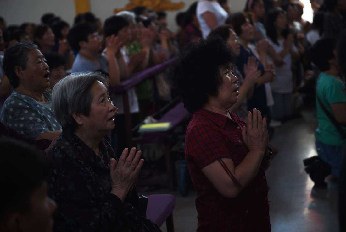 Chinese Catholics sing during a mass to mark the ascension of Jesus at a Catholic church in Tianjin, in northern China on May 24, 2015