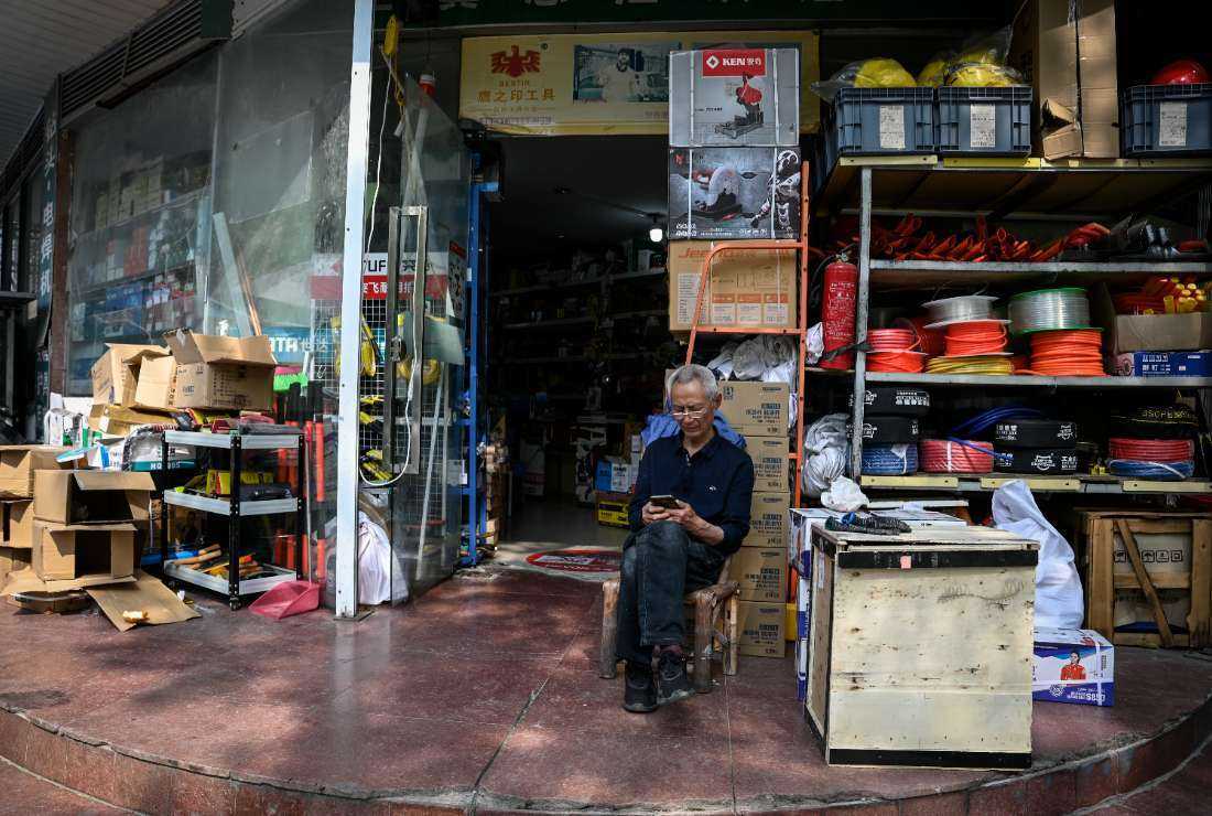 This photo taken on April 27 shows an elderly man sitting in front of a store in Rudong, in eastern China’s Jiangsu province. Rudong once played a pioneering role in the rollout of Beijing's one-child policy