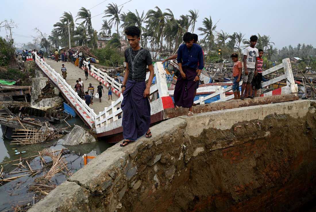 People cross a broken bridge at the Khaung Dote Khar Rohingya refugee camp in Sittwe, on May 15 after Cyclone Mocha made a landfall