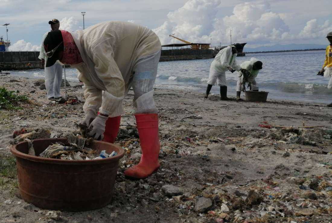 Workers clean up a beach in Zamboanga province of the Philippines in this undated photo