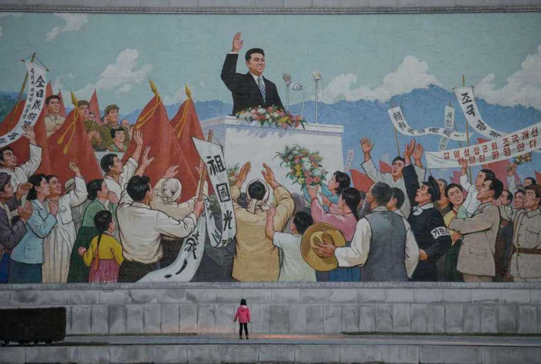 A child stands before a propaganda mosaic in Pyongyang on Dec 1, 2016