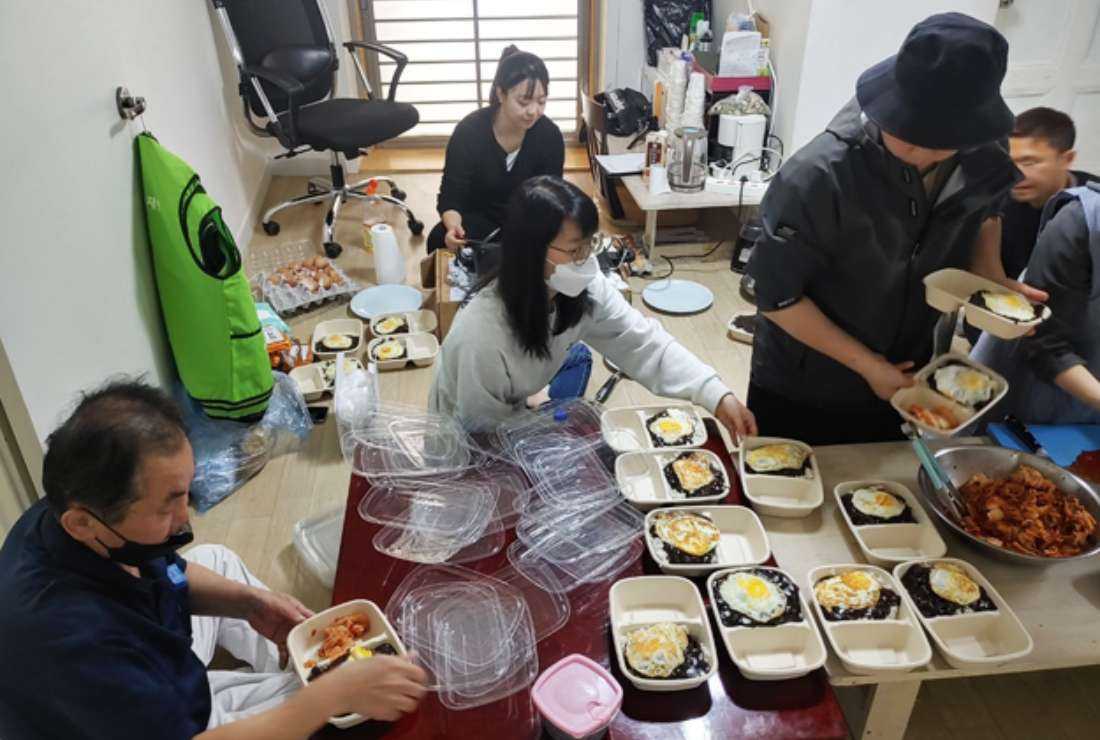 Young Korean Catholics prepare lunch boxes for homeless and hungry people in Seoul