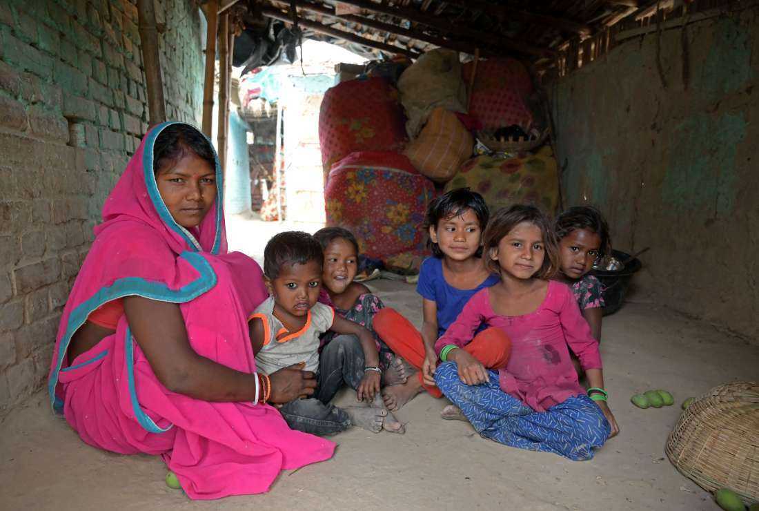 In this photograph taken on April 27, Gita Devi, mother-of-five, poses with her children at her village house in Darbhanga district of India's Bihar state