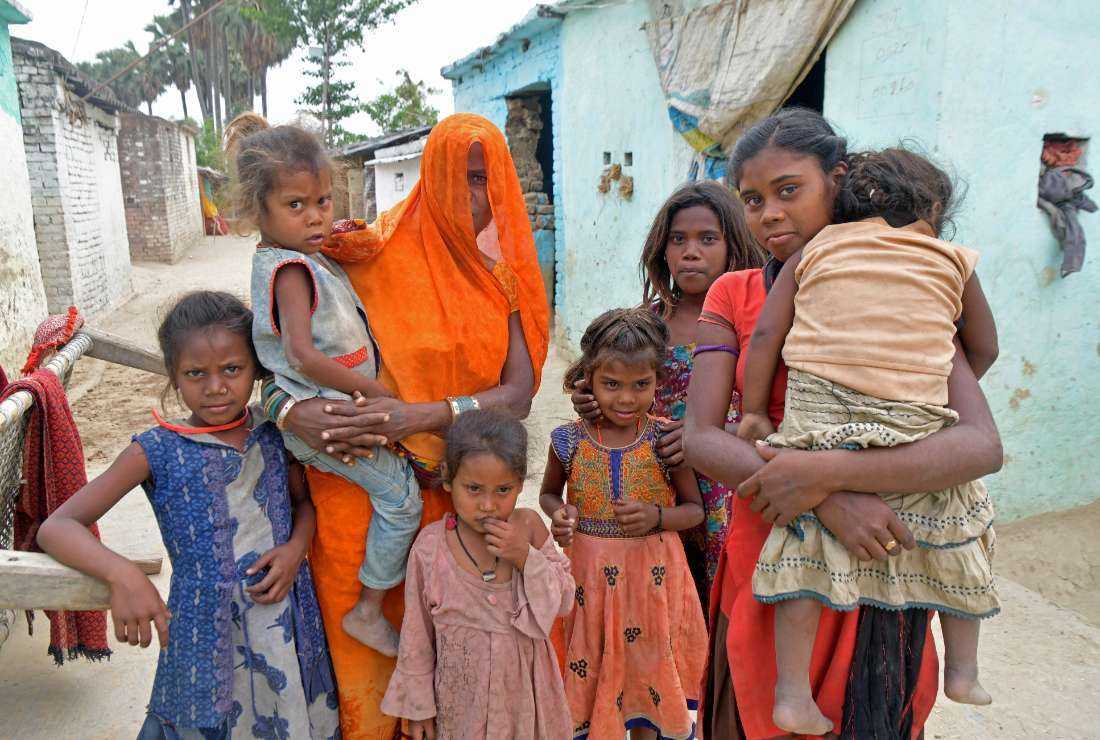 In this photograph taken on April 27, Sita Devi (center), mother-of-two, who is expecting another child, poses in a village in Darbhanga district of India's Bihar state