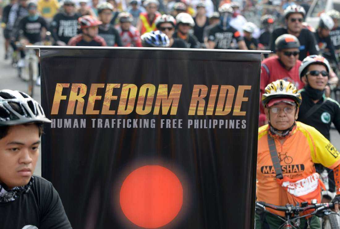 Hundreds of cyclists ride along a road in Manila's business district in this March 9, 2013 file photo in support of a global campaign against human trafficking