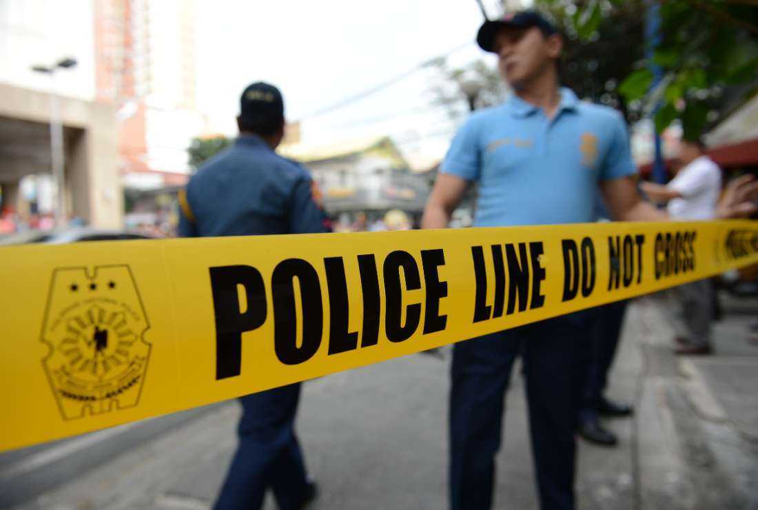 Philippine policemen stand next to a police cordon line during a simulation of a mall robbery in Manila on Feb. 6, 2013, as part of heightened security