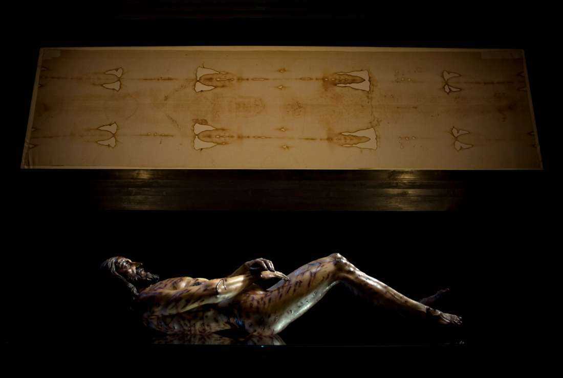 An image of Christ is displayed next to a facsimile of 'The Shroud of Turin' at the Cathedral of Malaga, on Feb. 20, 2012