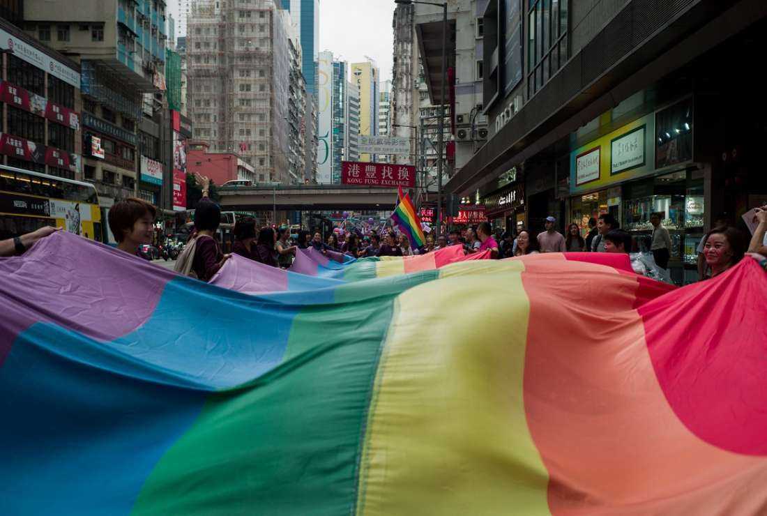 Participants hold a large rainbow flag as they take part in the annual pride parade at Victoria Park in Hong Kong on Nov 17, 2018. Some fear Beijing's crackdown on opposition endangers progress towards LGBTQ equality in Hong Kong