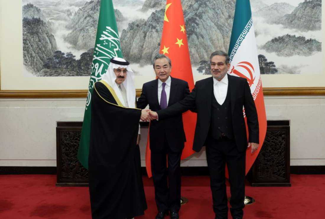 Representatives of Iran and Saudi Arabia are pictured with a Chinese diplomat (center) during a meeting