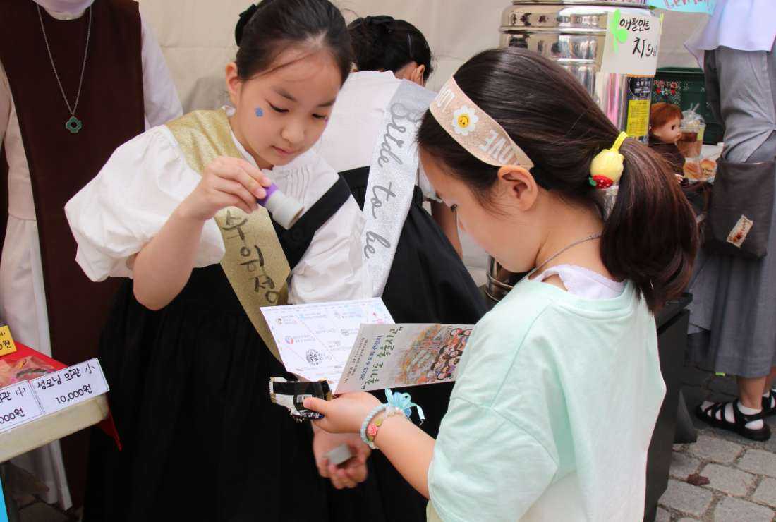 Children are seen at one of the stalls by religious groups during a special program for religious congregations in Seoul, South Korea on May 21