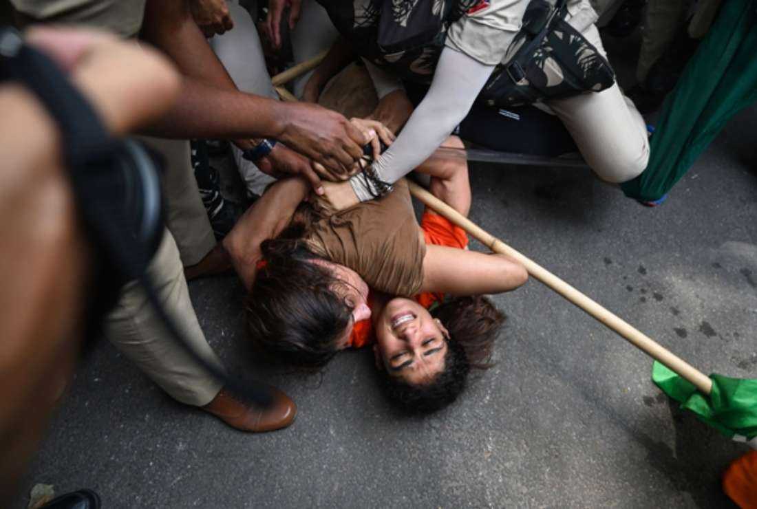 Indian wrestlers Sangeeta Phogat and Vinesh Phogat struggle as they are detained by the police while attempting to march to India's new parliament, just as it was being inaugurated by Prime Minister Narendra Modi, during a protest against Brij Bhushan Singh, the wrestling federation chief, over allegations of sexual harassment and intimidation, in New Delhi on May 28