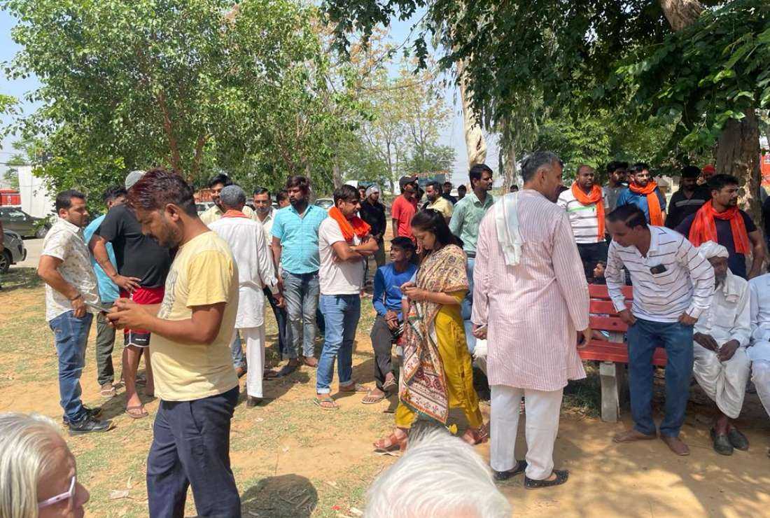 Villagers wait outside Farrukh Nagar police station in Gurgaon in Haryana following the complaint against the functioning of the church on June 1