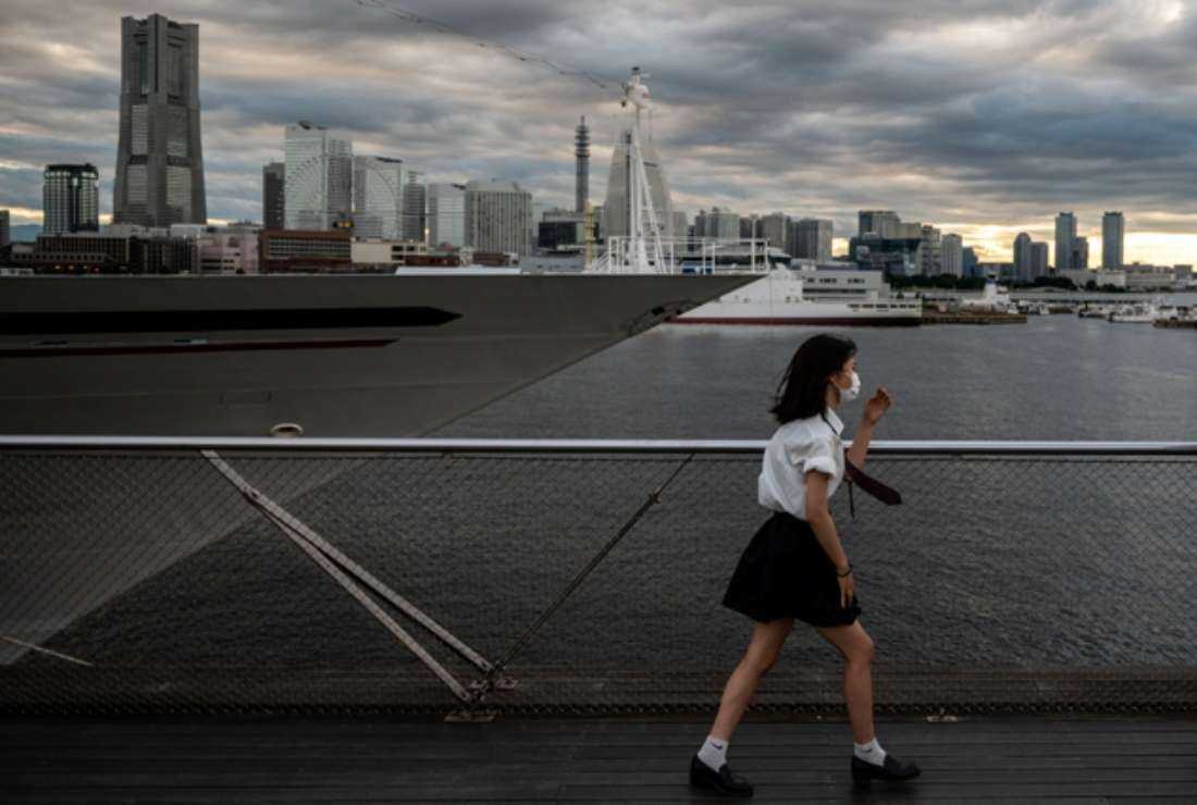 A Japanese youth walks along a rooftop area of Osanbashi Pier in Yokohama on July 27, 2021