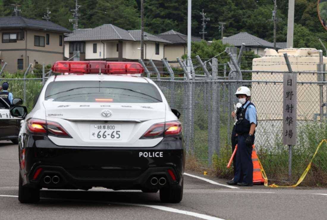 A police vehicle enters the grounds at the Hino basic firing range in the city of Gifu where a new military recruit shot and killed two fellow soldiers and wounded a third in central Japan on June 14