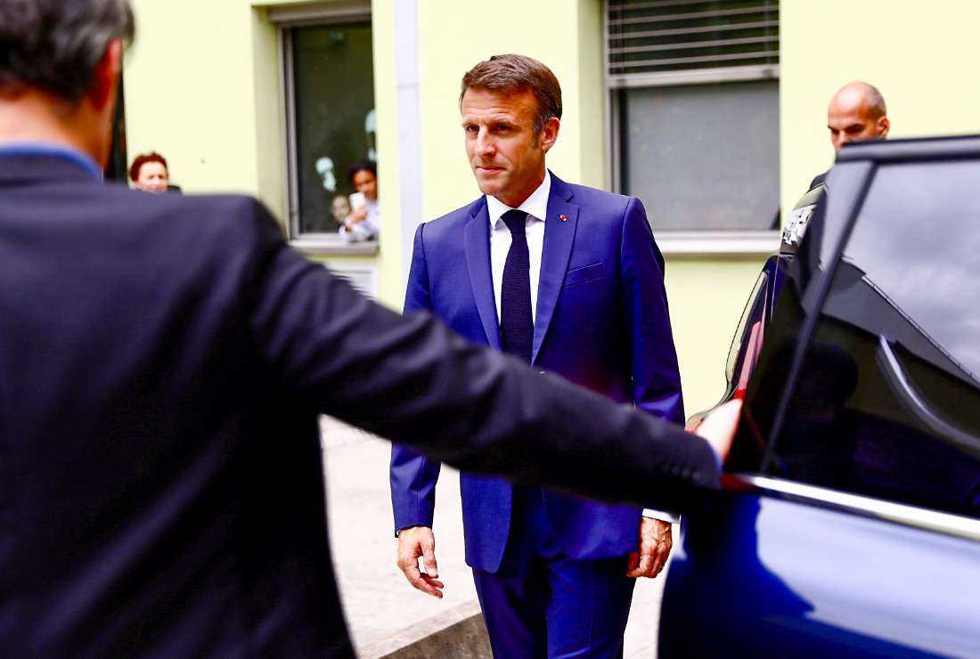 France's President Emmanuel Macron (center) leaves after he visited the victims of a knife attack at the University hospital (CHU) in Grenoble, in the French Alps, on June 9, 2023, a day after a mass stabbing in the park of the city