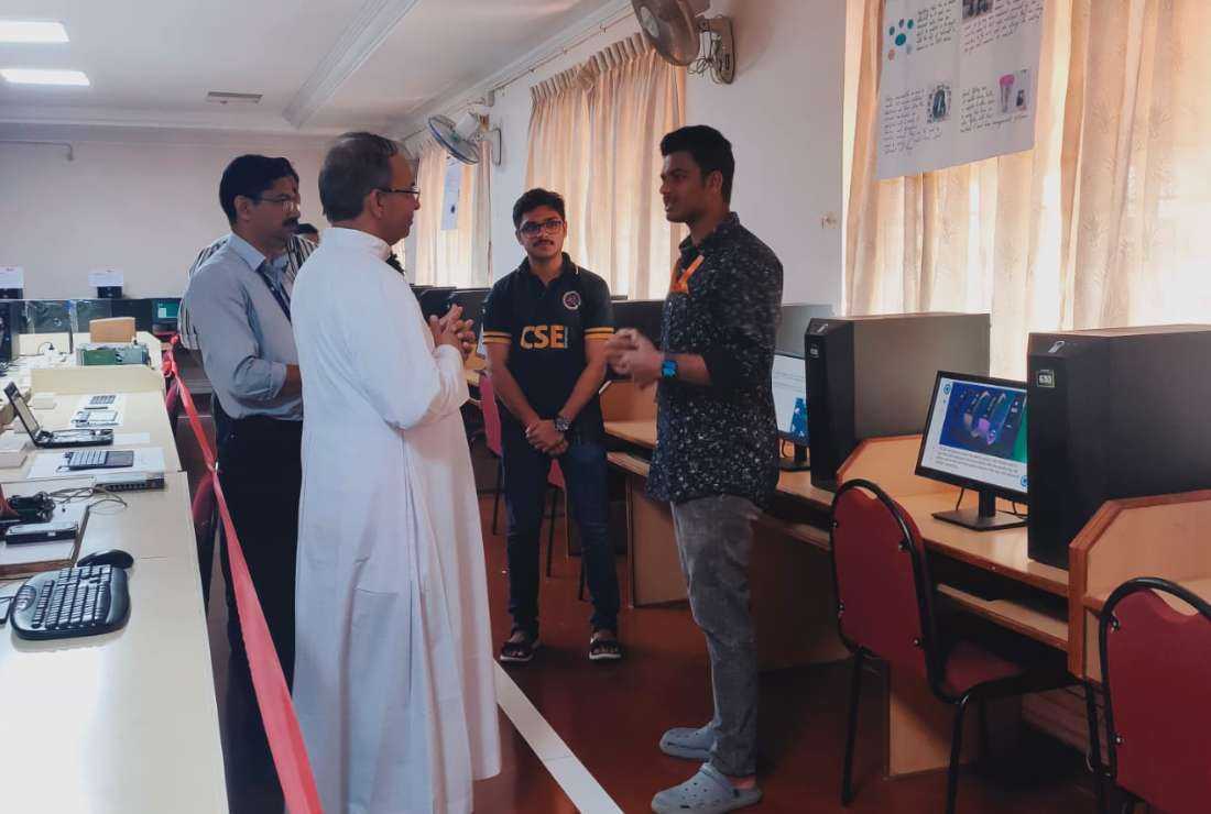 A priest listens to students at the open house session in Amal Jyothi College in Kanjirappilly diocese in the southern Indian state of Kerala, in November 2022