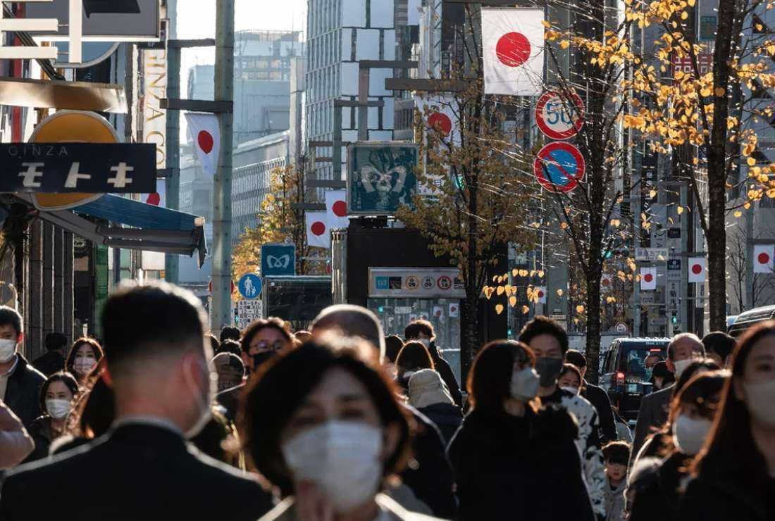 Pedestrians walk along a street in Tokyo's Ginza district on Dec. 29, 2022