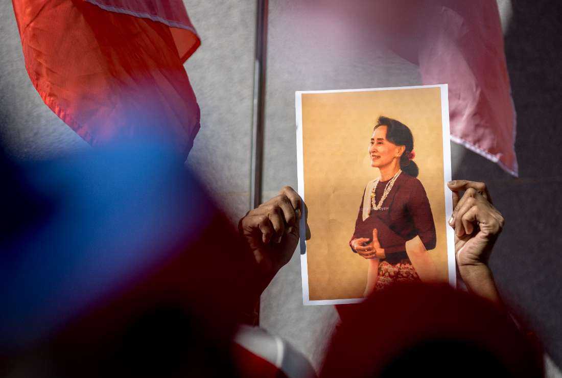A Burmese protester holds a photo depicting detained Myanmar civilian leader Aung San Suu Kyi during a demonstration outside the Embassy of Myanmar in Bangkok on Dec. 19, 2022, to mark International Migrants Day, which is held each year on December 18, and to voice opposition to the Myanmar military junta