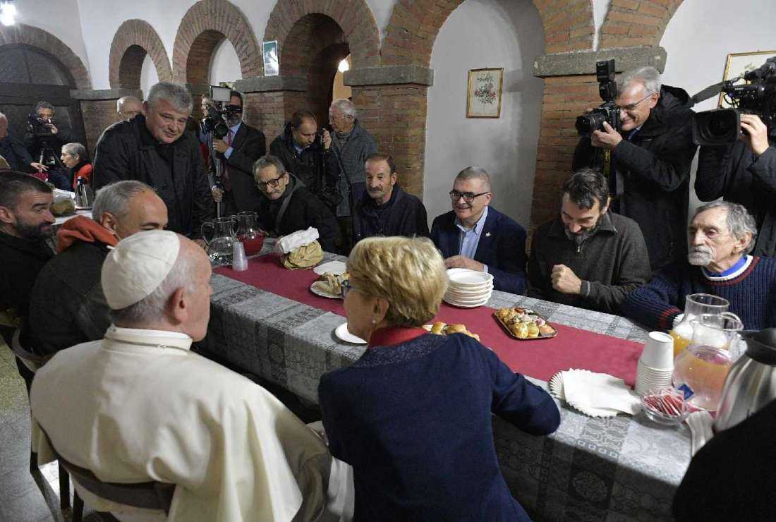 Pope Francis meets people as he inaugurates a new shelter, day center and soup kitchen for the poor in Palazzo Migliori across the street from St. Peter's Square in this file photo from Nov. 15, 2019
