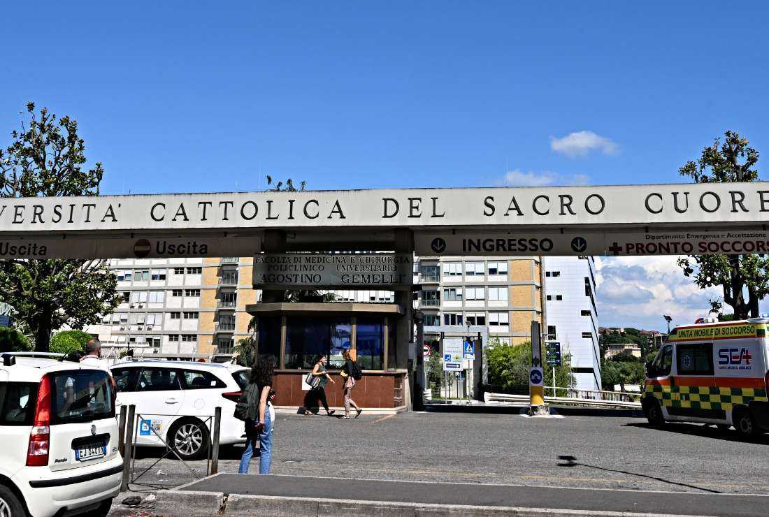 Pedestrians walk in front of the main entrance of Rome's Gemelli Hospital on June 8, where Pope Francis has been hospitalized