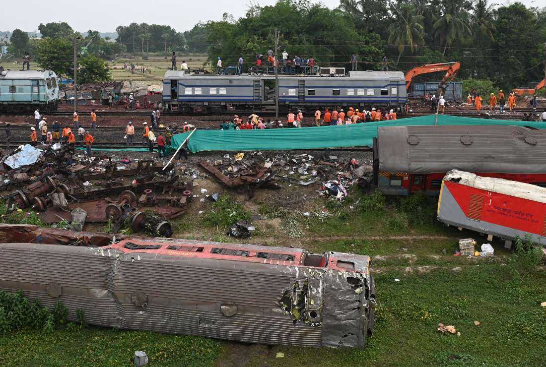 Railway workers help to restore services at the accident site of a three-train collision near Balasore, about 200 km (125 miles) from the state capital Bhubaneswar in the eastern state of Odisha, on June 4