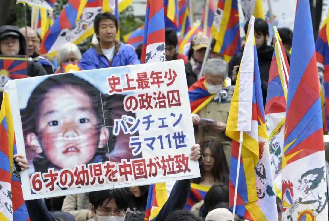 A protester holds a placard with a portrait of the Dalai Lama’s choice for Panchen Lama, Gedhun Choekyi Nyima in this file image