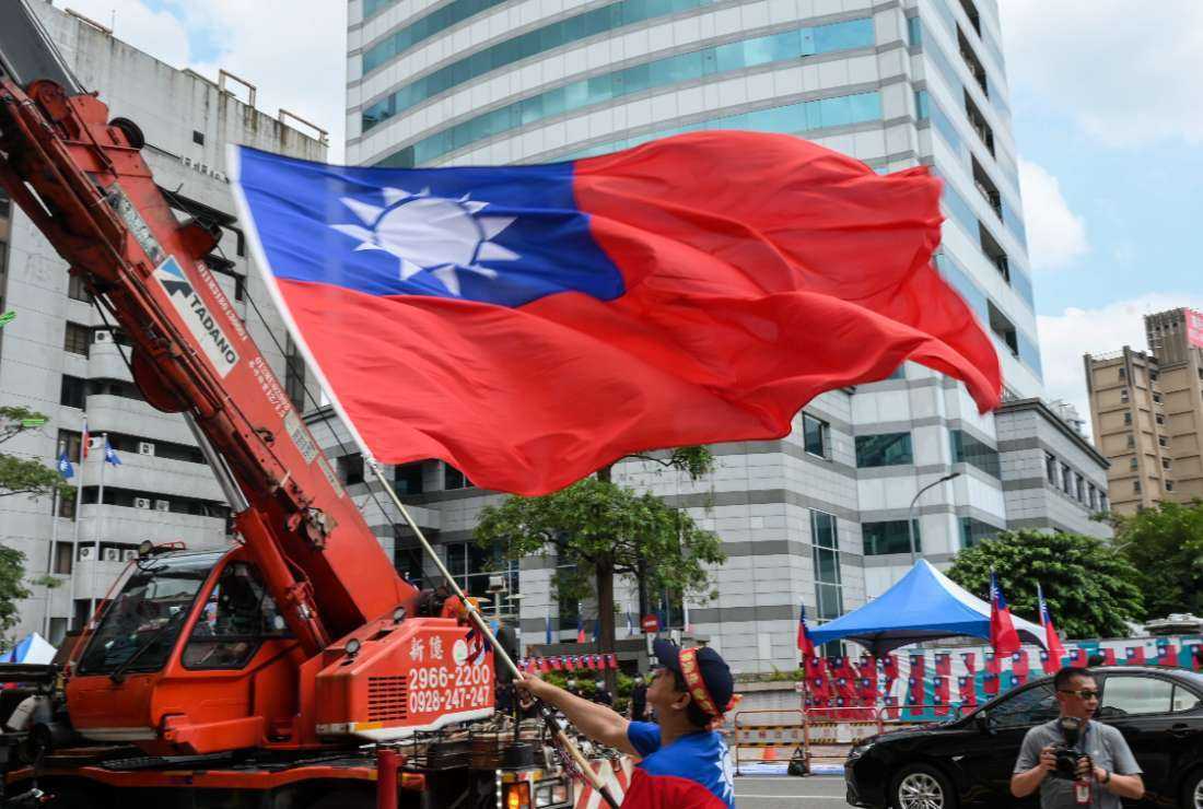 A supporter of the main opposition Kuomintang (KMT) waves a Taiwanese flag during a rally outside the KMT headquarters ahead of the party's expected announcement of their 2024 presidential candidate in Taipei on May 17. (Photo: AFP)