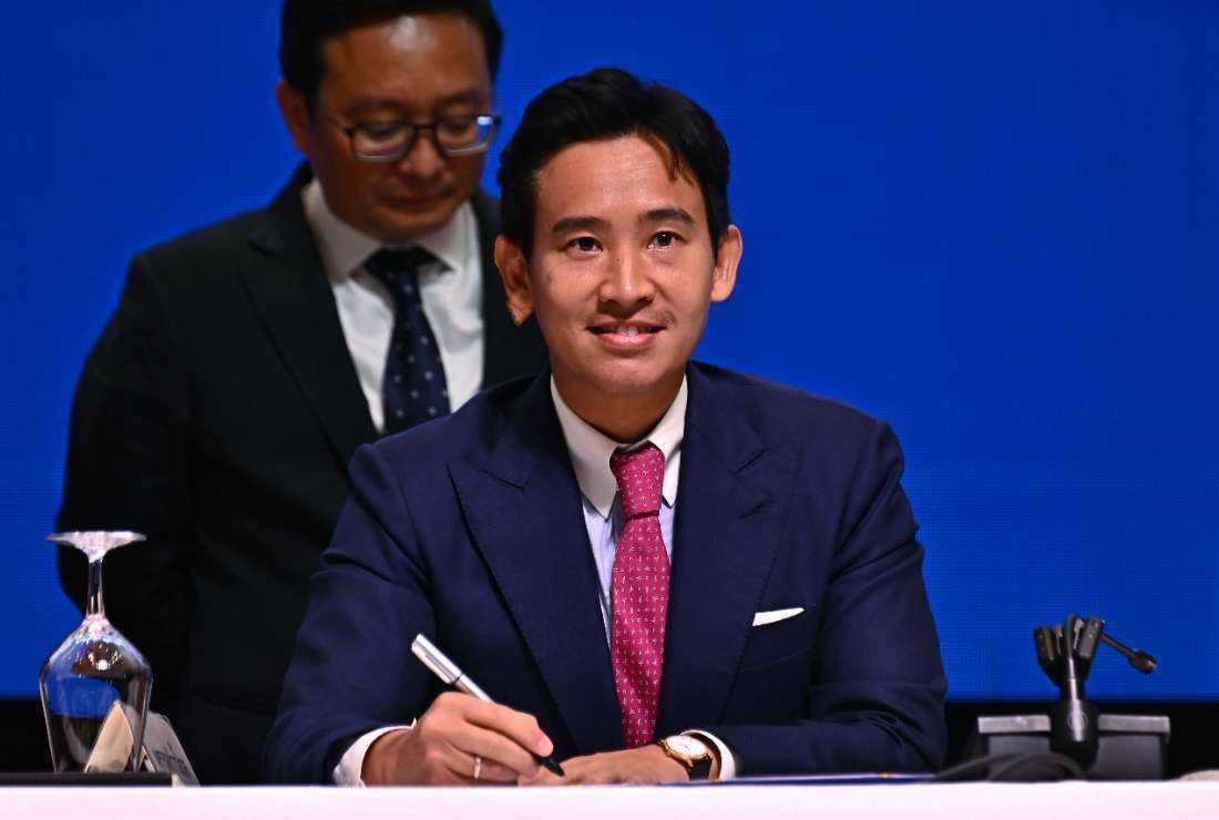 Move Forward Party leader and prime ministerial candidate Pita Limjaroenrat signs a memorandum of understanding (MOU) during a joint signing ceremony amongst eight Thai political parties in agreement to form a new government, in Bangkok on May 22