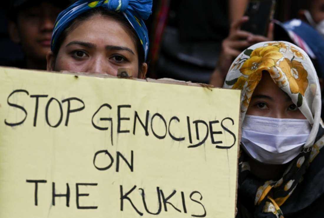 An activist of the All Tribal Students Union Manipur (ATSUM) holds a placard during a protest amid ongoing ethnic violence in India's northeastern Manipur state, in New Delhi on May 31