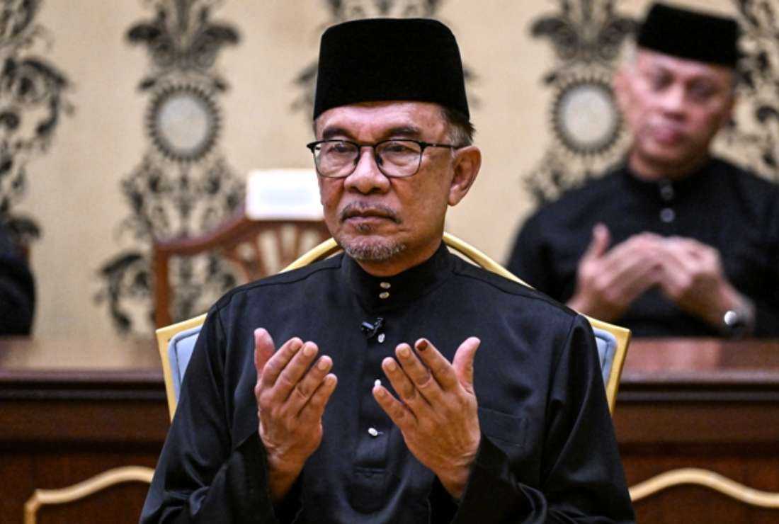 Malaysian Prime Minister, Anwar Ibrahim, offers prayers after taking the oath during his swearing-in ceremony at the National Palace in Kuala Lumpur on Nov. 24, 2022. His government has announced plans to enact the State and Nation Act to forbid any speech or content critical of race, religion, and royalty, that may lead to communal tensions