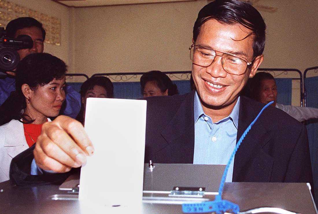 Cambodia's Prime Minister Hun Sen smiles while casting his vote in the election for the National Assembly in Phnom Penh on July 26, 1998