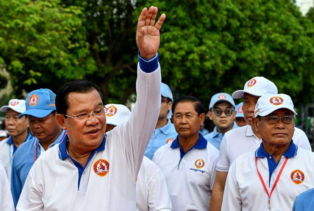 Cambodia's Prime Minister Hun Sen (L) waves to supporters on July 1 during a rally for the ruling Cambodian People's Party (CPP) ahead of the upcoming election in Phnom Penh. Cambodians go to the polls on July 23