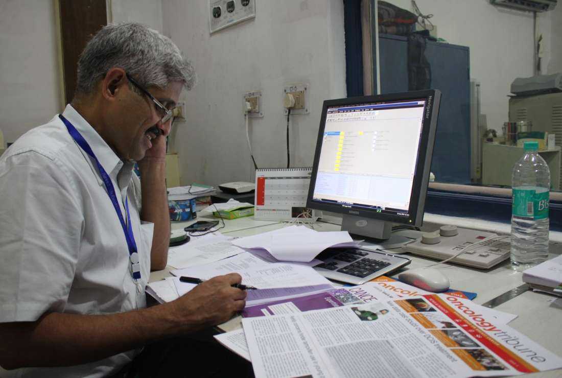 Dr. Ravi Kannan R., an Indian cancer specialist, is seen at his desk. He is among the four winners of this year's Ramon Magsaysay Award