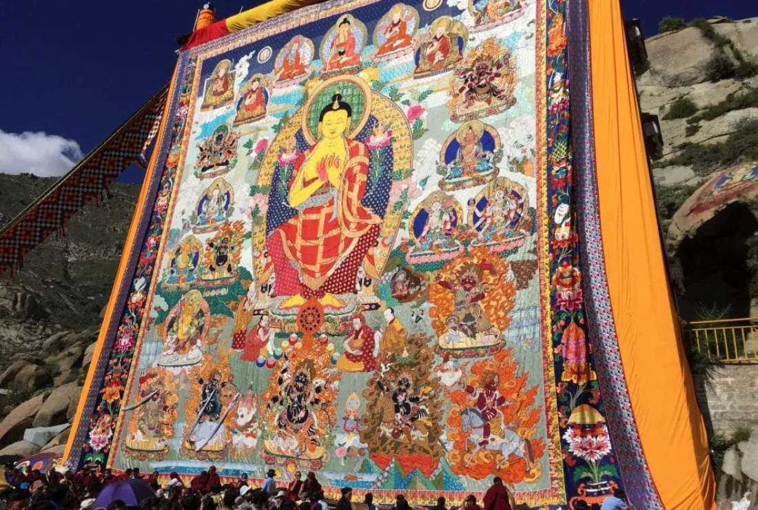 Tibetans gather in front a huge painting of Buddha during the yogurt festival in this file photo