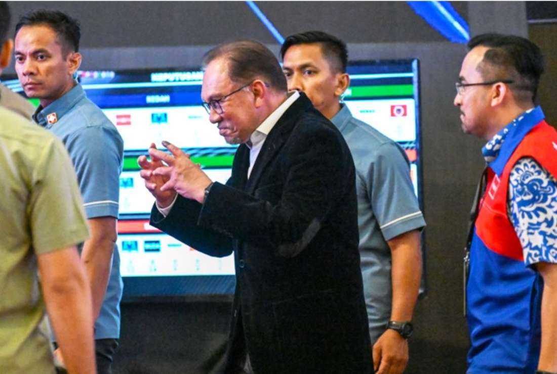 Malaysia's Prime Minister Anwar Ibrahim (center) gestures after the release of state election results at the World Trade Center in Kuala Lumpur on Aug. 12. Malaysians in six states went to the polls to vote for state assembly members in elections widely seen as a barometer of support for Ibrahim's unity government